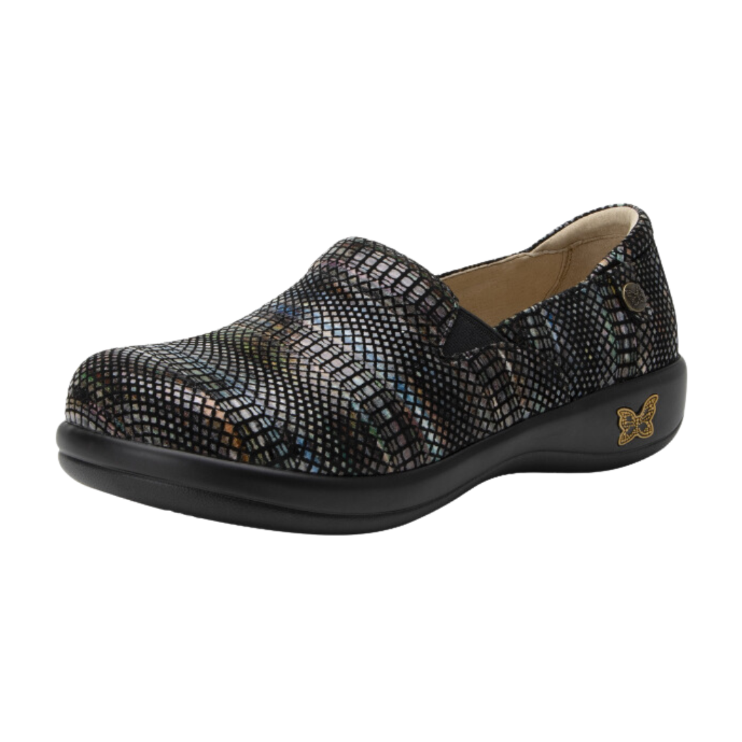 Angled view of Women’s Alegria Keli casual slip-on in black with multi-colors – featuring artistic printed upper, supportive footbed, breathable materials, and durable outsole.
