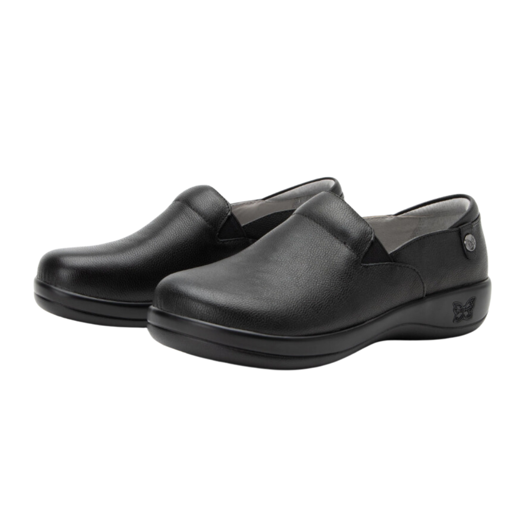 Angled view of Women’s Alegria Keli casual slip-on in all black – featuring smooth nappa leather upper, breathable lining, memory foam insole, and flexible rubber outsole.