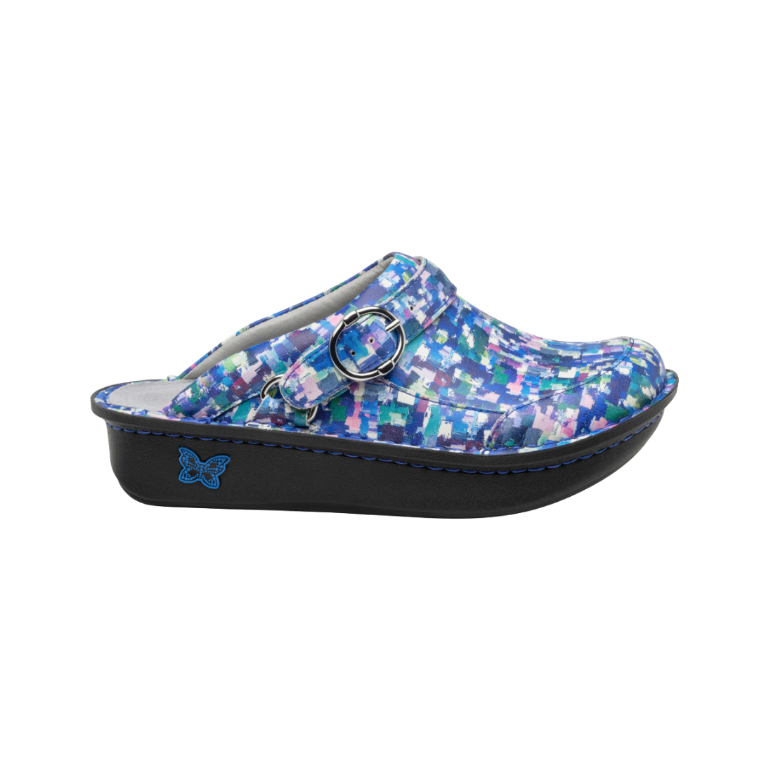 Side View of Women’s Alegria Seville clog in Welcome Back Blotter blue print – featuring a cushioned cork and memory foam footbed, swivel strap with adjustable buckle, and slip-resistant outsole for all-day comfort.