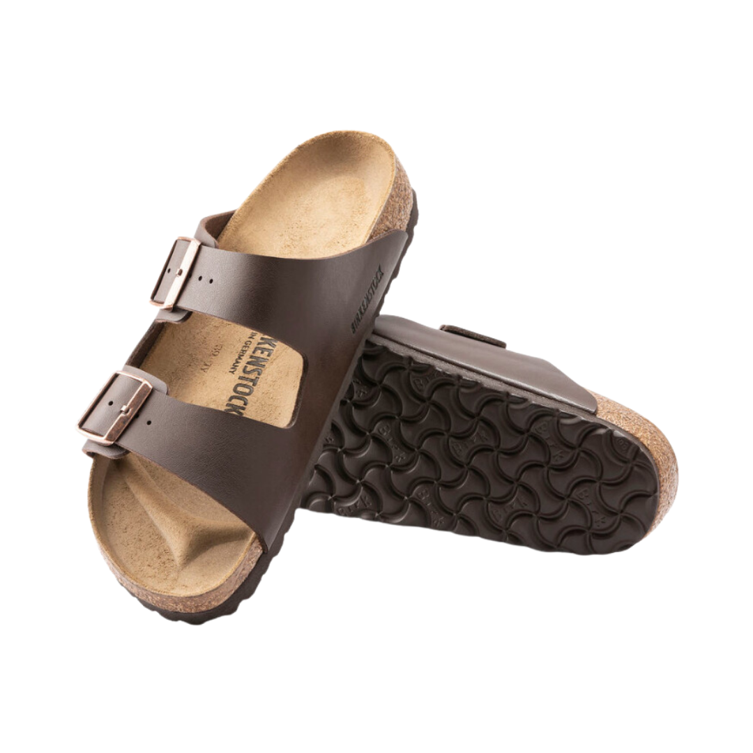 Angled view of Women’s Birkenstock Arizona Birko-Flor sandal in dark brown - featuring resilient Birko-Flor synthetic straps with adjustable buckles for a perfect fit, an anatomically shaped cork footbed that promotes healthy foot alignment, and a durable outsole for reliable traction and wear resistance.