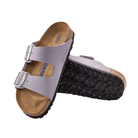 Angled view of Women’s Birkenstock Arizona Soft Footbed nubuck leather sandal in light purple (purple fog) - featuring breathable nubuck leather straps with adjustable buckles, a plush soft footbed lined with suede for moisture wicking, and a cork footbed that provides support and comfort for extended wear.