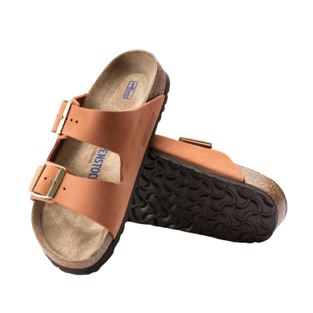 Angled view of Women’s Birkenstock Arizona Soft Footbed nubuck leather sandal in burnt orange - crafted with soft nubuck leather straps, cushioned soft footbed for added comfort, and a cork sole designed to support foot health and provide excellent shock absorption.