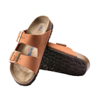 Angled view of Women’s Birkenstock Arizona Soft Footbed nubuck leather sandal in burnt orange - crafted with soft nubuck leather straps, cushioned soft footbed for added comfort, and a cork sole designed to support foot health and provide excellent shock absorption.