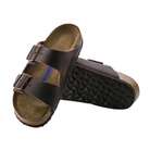 Angled view of Men’s Birkenstock Arizona Soft Footbed sandal in dark brown – with oiled leather straps and cork footbed for added softness and comfort.
