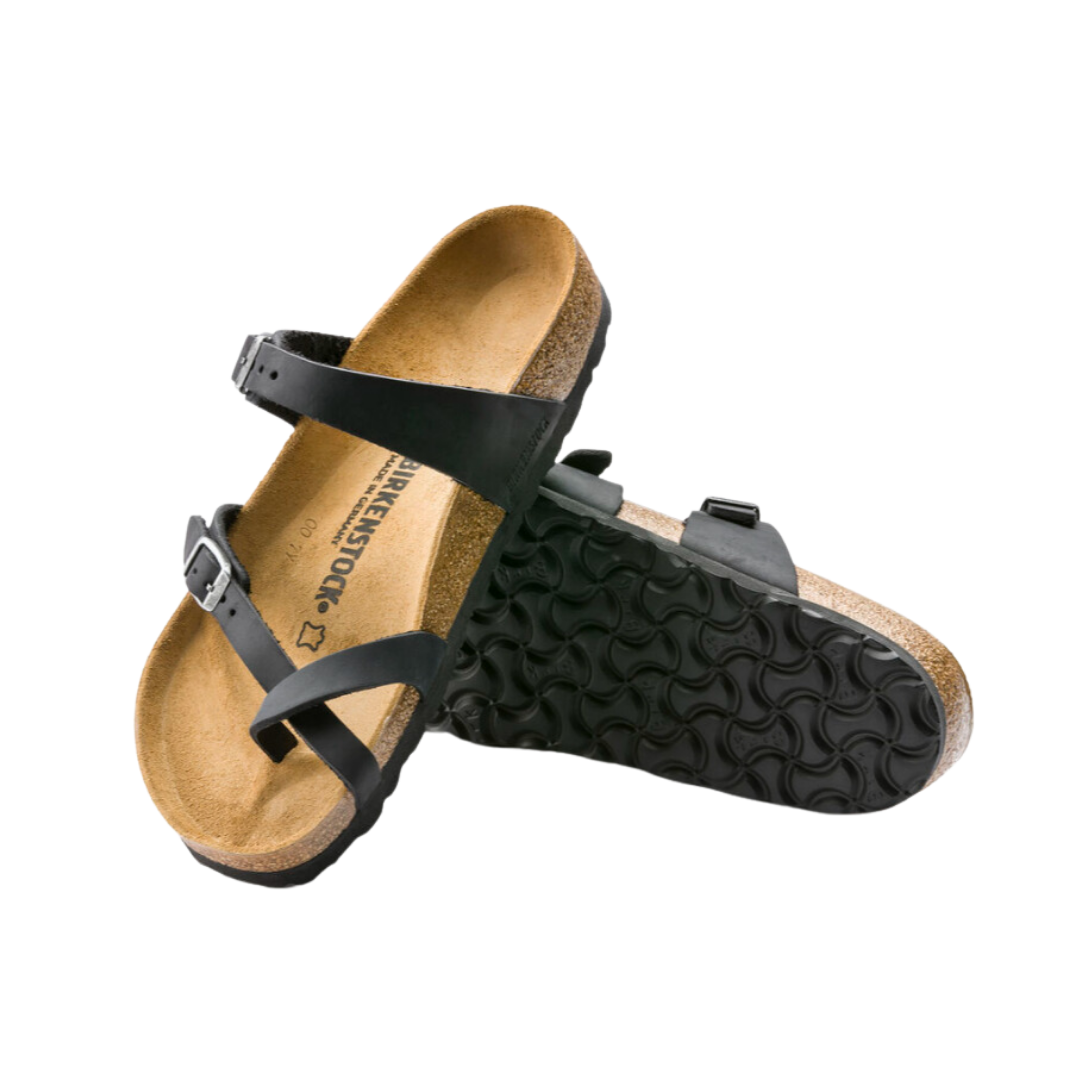 Angled view of Women’s Birkenstock Mayari oiled leather sandal in black - designed with premium oiled leather straps for a rich, polished look, an adjustable toe strap for personalized fit, and a cork footbed that molds to the contours of your foot for superior comfort and support.