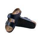 Angled view of Women’s Birkenstock Arizona Soft Footbed oiled leather sandal in dark blue - showcasing premium oiled leather straps with a rich finish, a soft footbed that molds to your foot for exceptional comfort, and a resilient cork sole engineered for shock absorption and durability.