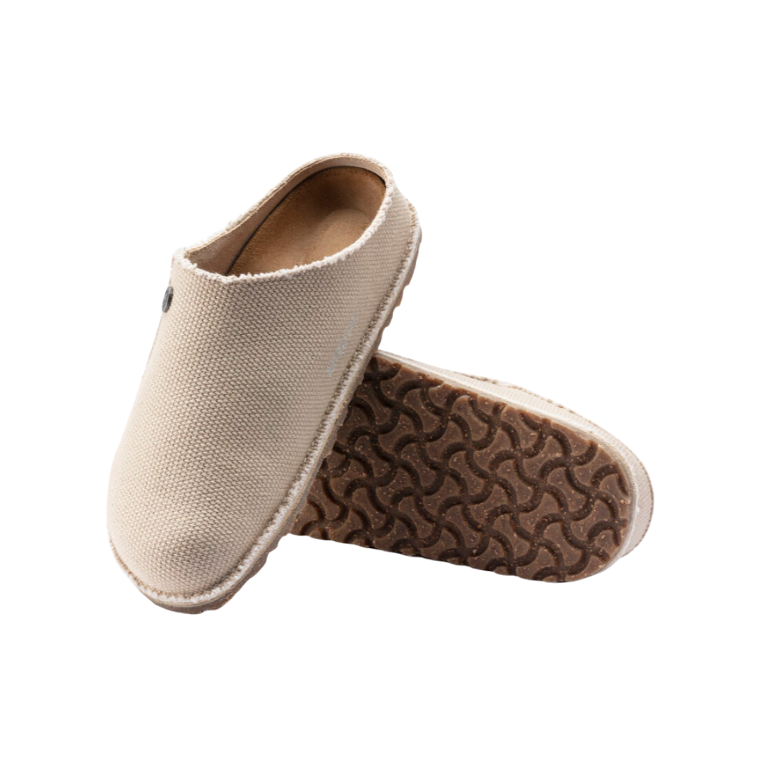Side view of Women’s Birkenstock Zermatt Canvas slipper in tan textile – featuring breathable textile upper, cushioned cork footbed for arch support, slip-resistant sole, and soft interior lining for warmth and comfort.