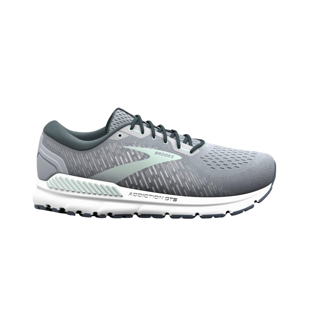 Side view of Women’s Brooks Addiction GTS 15 running shoe in grey, navy, and aqua – featuring engineered mesh upper for breathability, GuideRails support system for stability, and BioMoGo DNA midsole for adaptive cushioning.