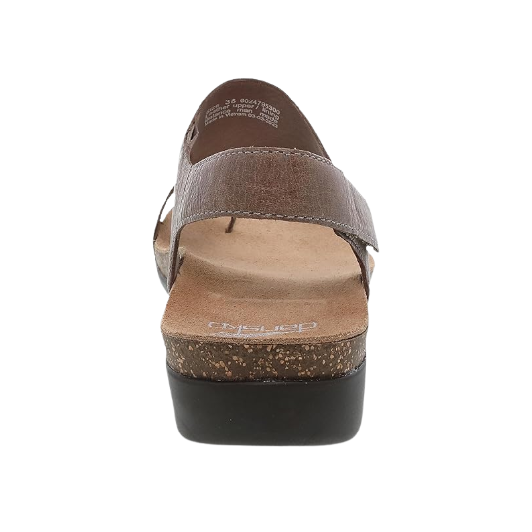 Back view of Women’s Dansko Reece sandal in stone waxy – featuring a back strap with adjustable hook-and-loop closure, cushioned heel support, and clean seam finish.