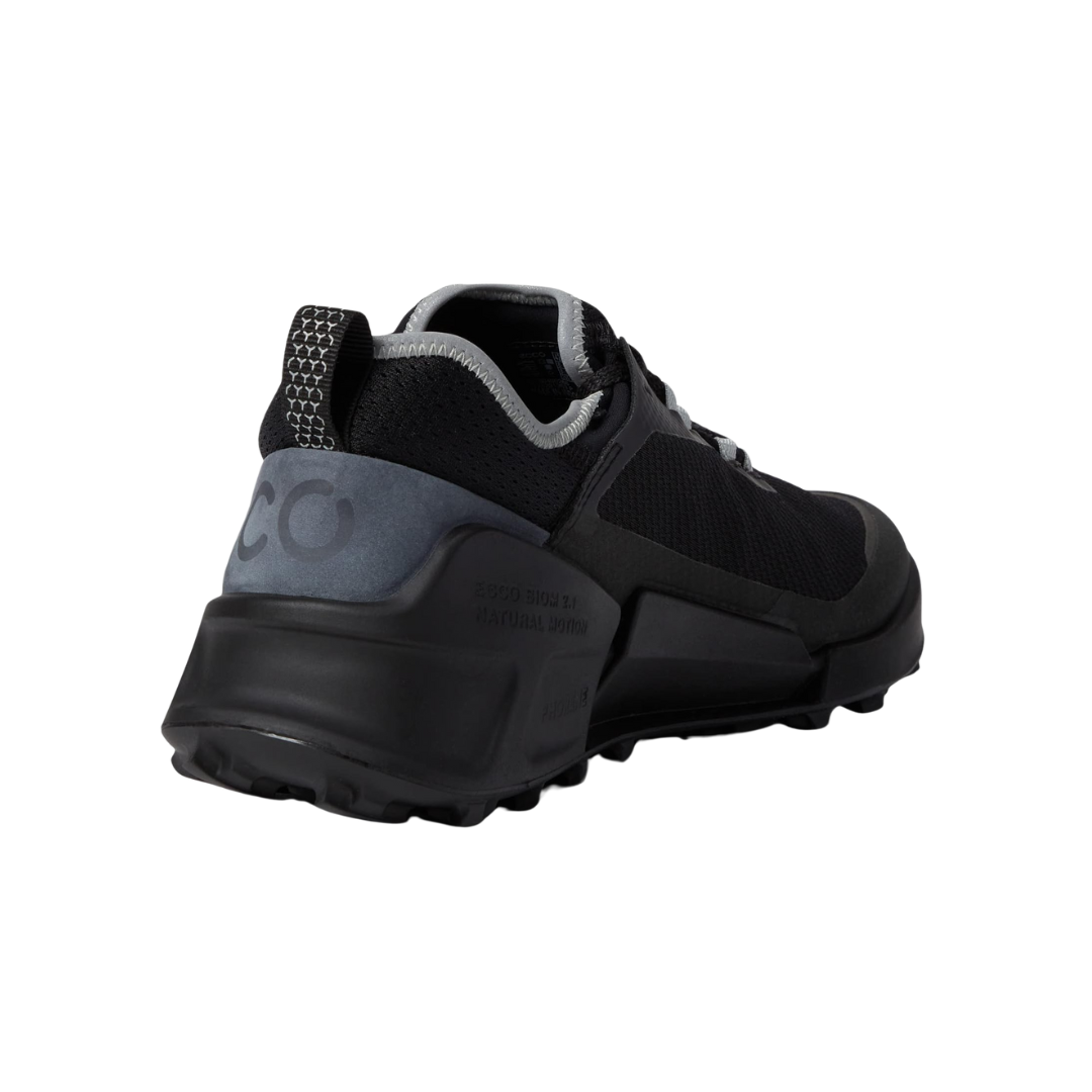 Angled view of Men’s Ecco BIOM 2.1 X-Country Low hiking shoe in black and magnet – featuring ergonomic footbed with anatomical arch support to reduce foot fatigue, lightweight midsole with shock absorption, and reinforced toe cap for protection.
