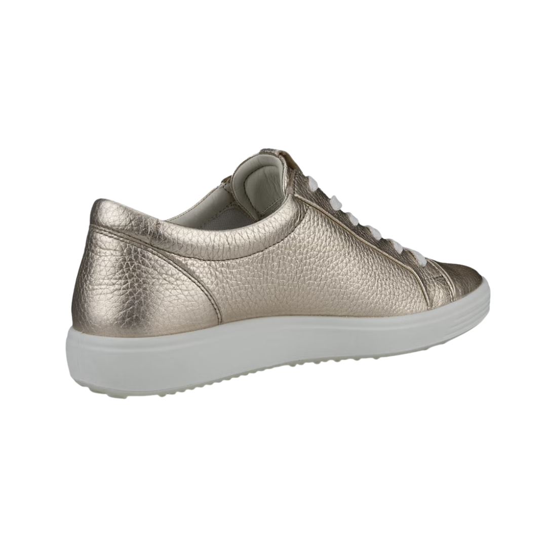 Angled View of Women’s ECCO Soft 7 Sneaker in Pure White/Gold – featuring sleek low-top silhouette, subtle gold accents for a touch of luxury, and minimalist design for everyday versatility.