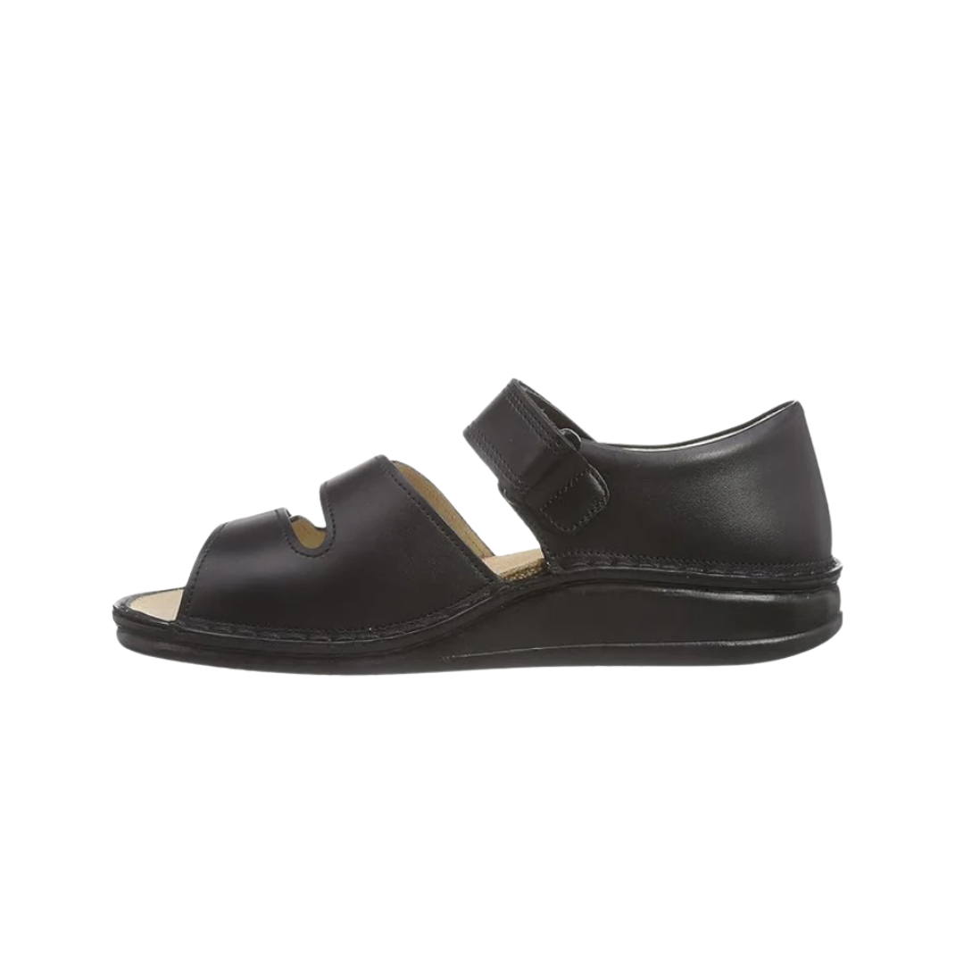 Side View of Women’s Finn Comfort Baltrum sandal in Black Nappa leather – featuring three adjustable hook-and-loop straps, a full heel cover for added stability, and a removable orthopedic cork footbed for superior arch support and all-day comfort.