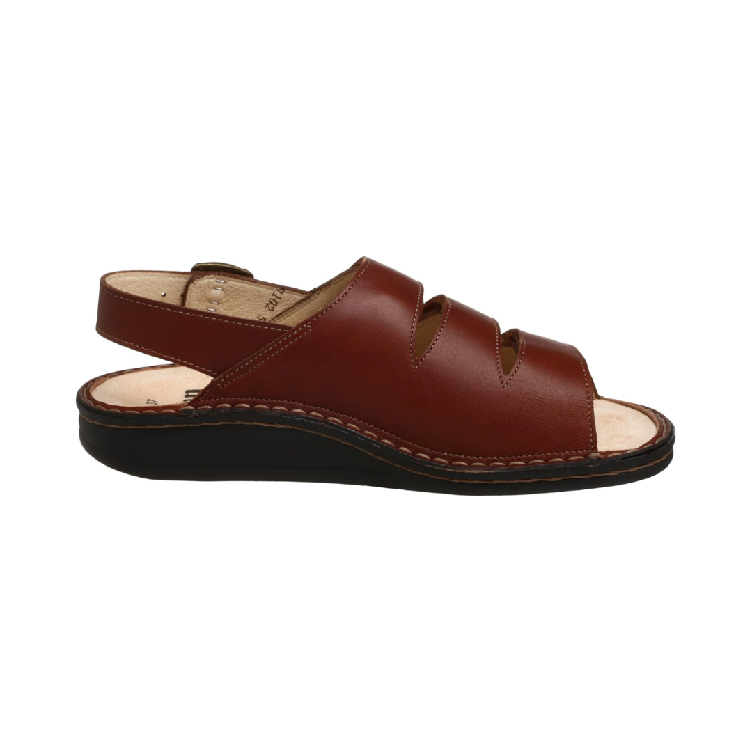Side View of Women’s Finn Comfort Sylt sandal in Brandy leather – featuring a premium leather upper with three adjustable hook-and-loop straps, a backstrap with buckle closure for a secure fit, and a flexible polyurethane sole handstitched to the upper.