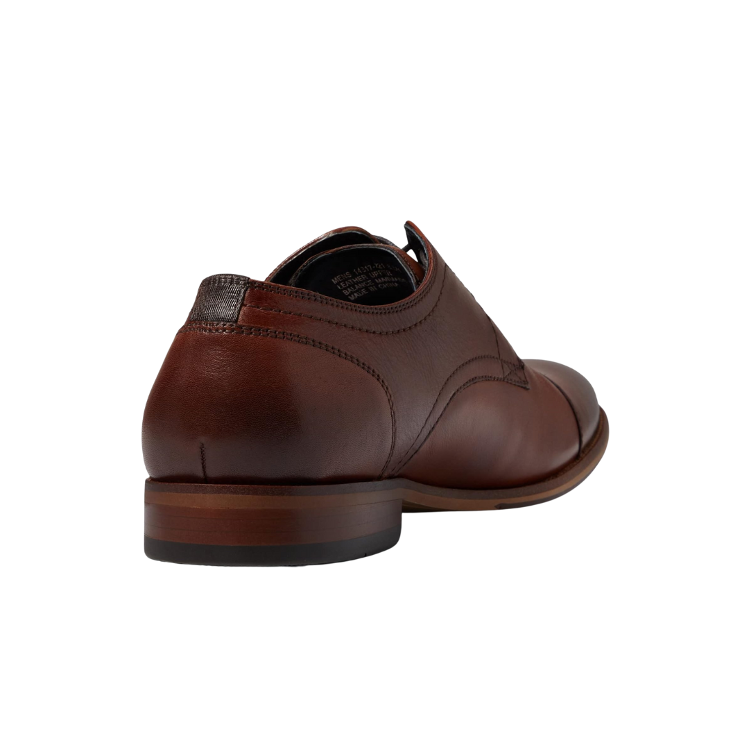 Back view of Men’s Flex Cap-Toe Oxford in Cognac – showing a gently contoured heel with smooth leather finish, discreet stitching, and subtle seam detailing for a tailored, supportive fit.
