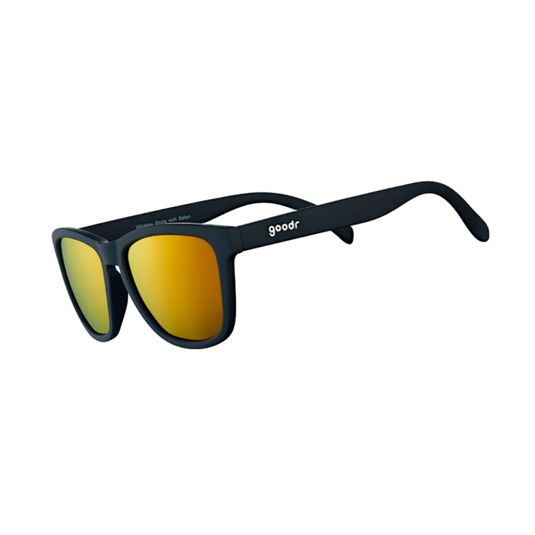 Angled View of Unisex Goodr The OG Sunglasses Whiskey Shots with Satan in Matte Black Frame with Amber Mirrored Lenses – featuring classic full-rim frame for bold style, polarized lenses for glare protection, and lightweight design for comfortable all-day wear.