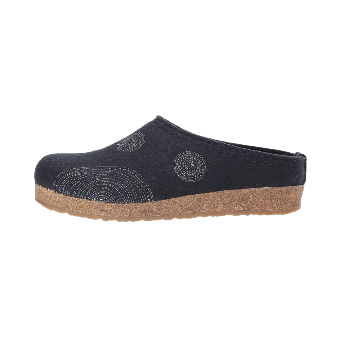 Side view of Haflinger Women's Spirit in Navy – featuring a cozy wool upper with decorative spiral stitching, a cushioned footbed for arch support, and a slip-on silhouette built for everyday wear around the house.