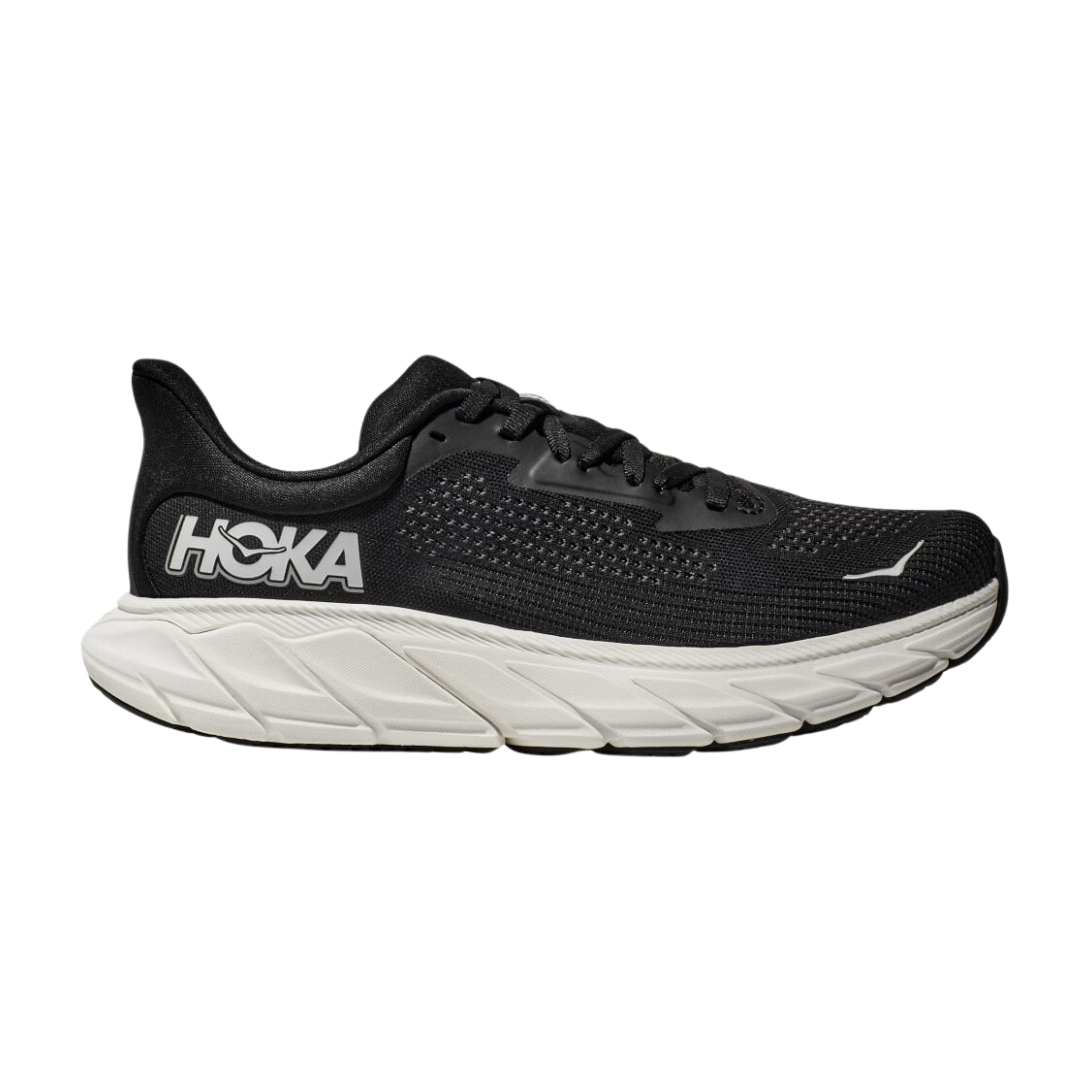 Side view of Women’s Arahi 7 running shoe in black and white – featuring engineered mesh upper for breathability, GuideRails support system to stabilize the foot and prevent overpronation, and responsive midsole cushioning for shock absorption.