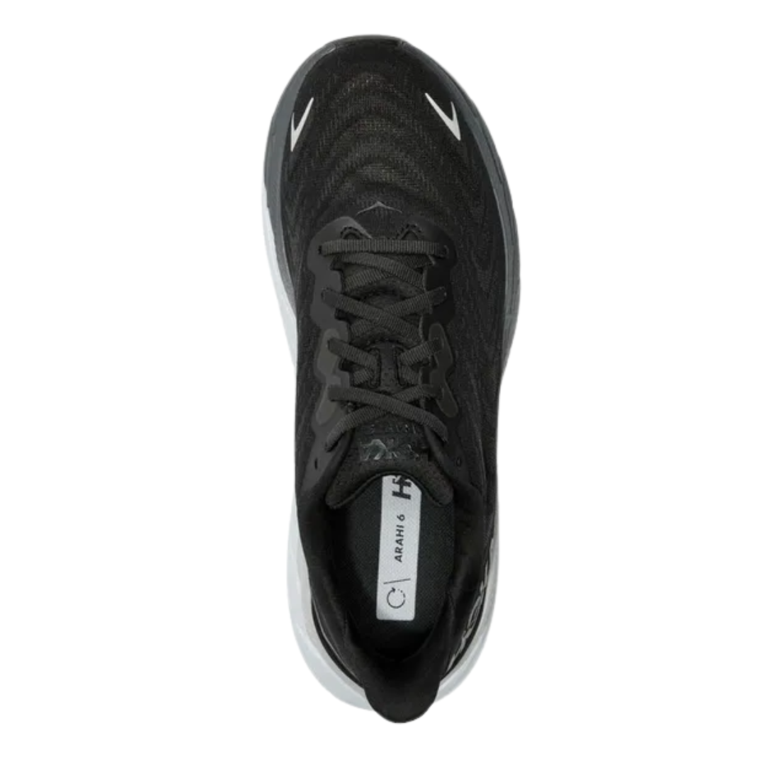 Top view of Men’s Arahi 6 running shoe in black and white – featuring padded tongue and collar for comfort, moisture-wicking lining to keep feet dry, and secure lace-up closure for locked-in fit.