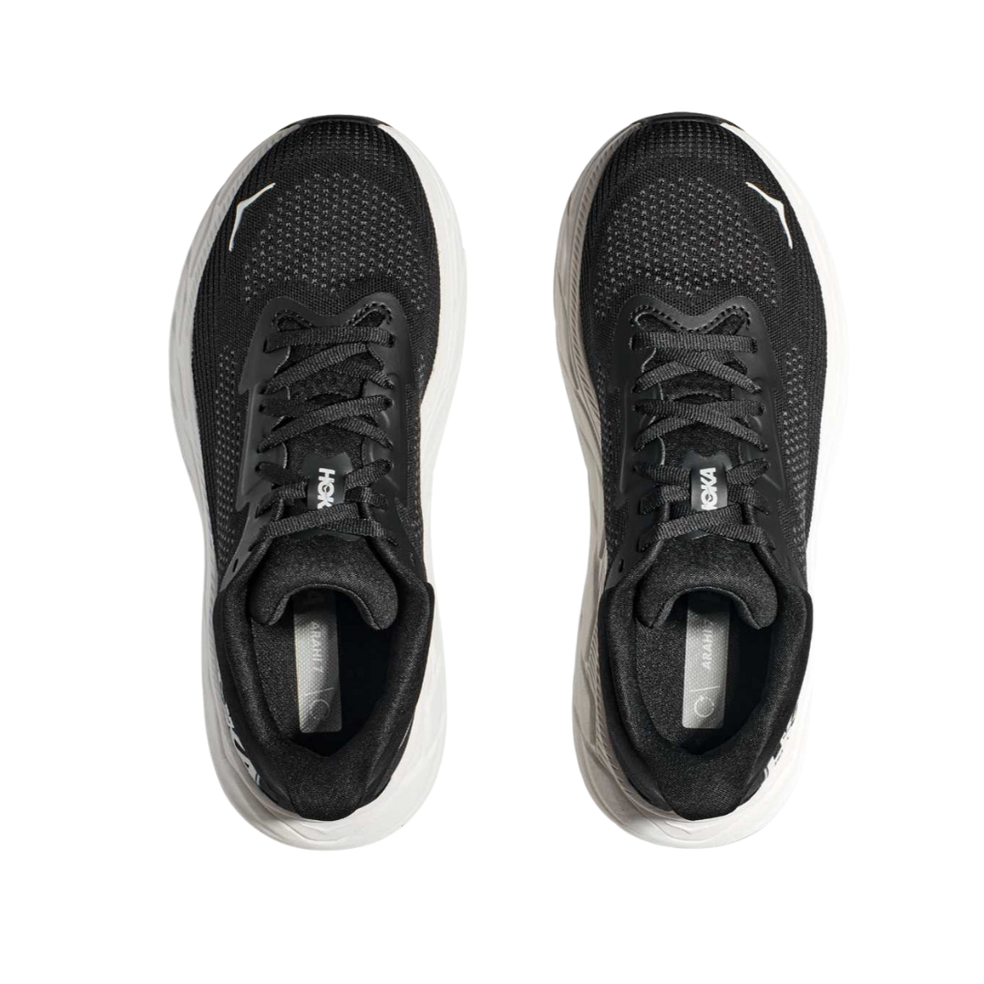 Top view of Women’s Arahi 7 running shoe in black and white – featuring padded tongue and collar for comfort, moisture-wicking lining to keep feet dry, and secure lace-up closure for locked-in fit.