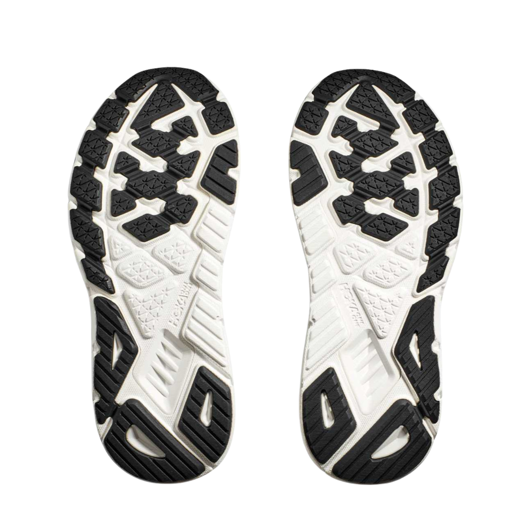 Bottom view of Women’s Arahi 7 running shoe in black and white – featuring durable rubber outsole with segmented crash pad for smooth heel-to-toe transition, flex grooves for natural foot movement, and multi-surface traction for versatile grip.