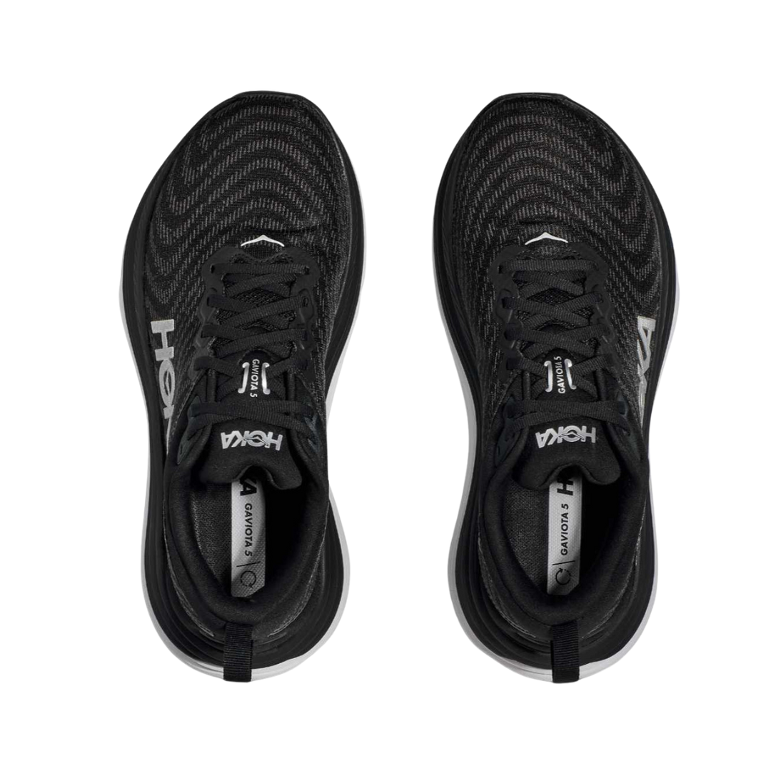 Top view of Women’s Gaviota 5 running shoe in black and white – featuring padded tongue and collar for comfort, moisture-wicking lining to keep feet dry, and secure lace-up closure for locked-in fit.