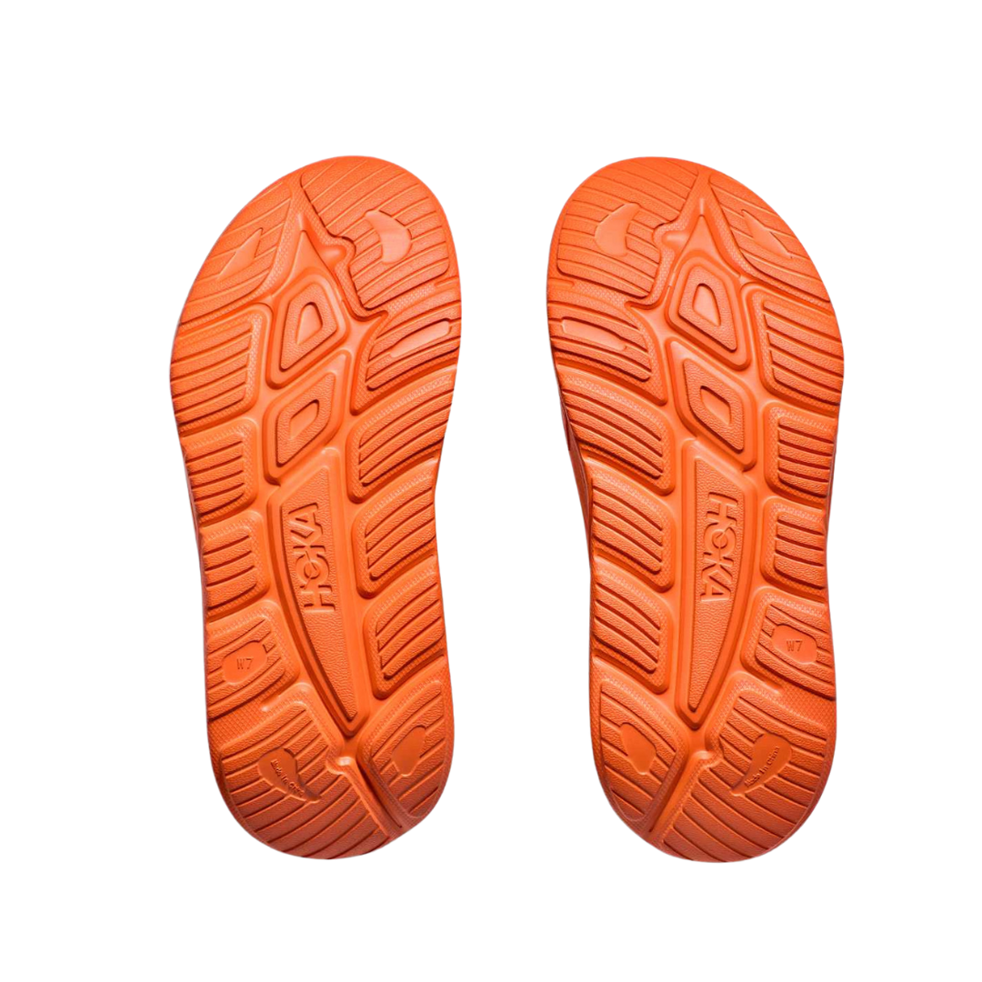 Bottom view of Unisex Ora Recovery Slide 3 in orange – featuring a textured rubber outsole for slip resistance, flexible sole for natural foot movement, and durable construction for everyday use.