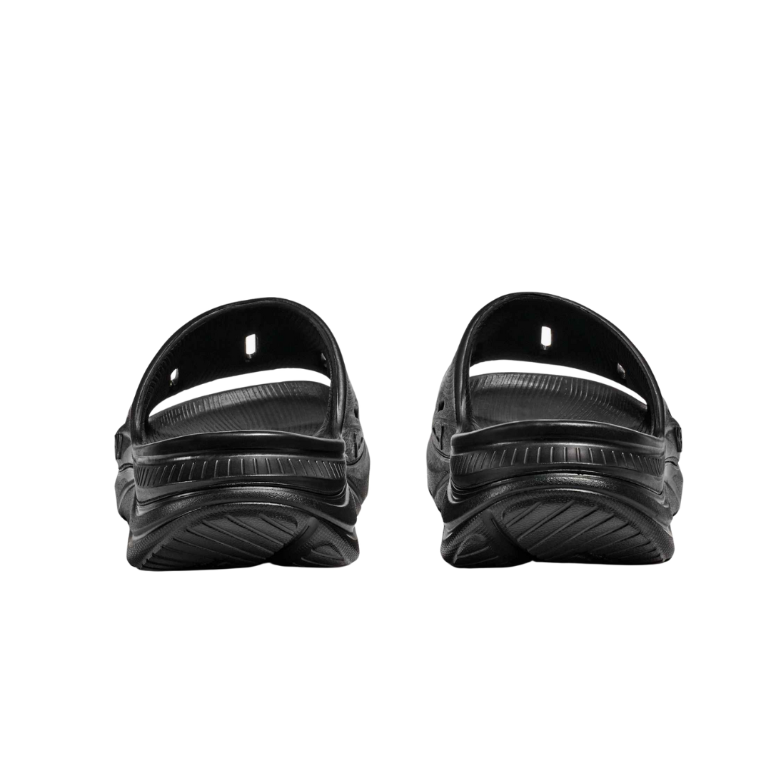Back view of Men’s Ora Recovery Slide in black – featuring slightly raised heel for natural foot alignment, flexible sole for ease of movement, and durable outsole for traction.