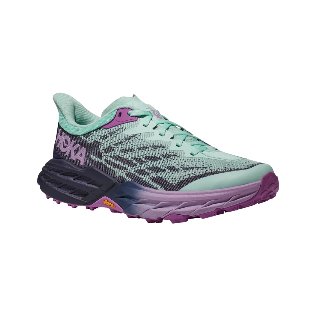 Angled view of Women’s Speedgoat 5 trail running shoe in sunlit ocean and night sky – featuring ergonomic footbed with anatomical arch support to alleviate plantar fasciitis and neuropathy discomfort, breathable mesh panels for ventilation, and cushioned heel for impact protection.