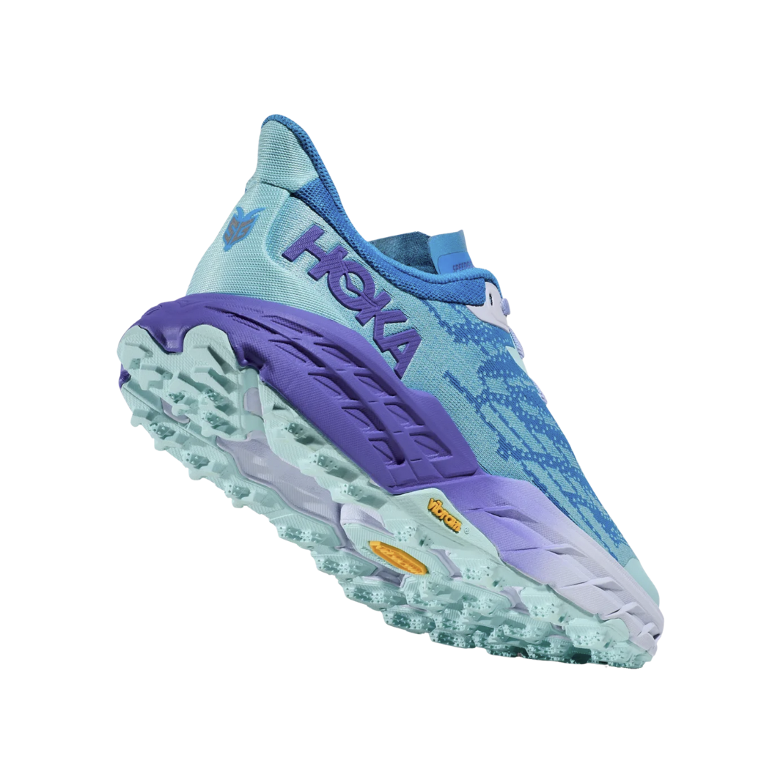 Angled View of Women’s HOKA Speedgoat 5 Trail Running Shoe in Cloudless/Cosmos – featuring lightweight cushioned midsole, supportive upper design for rugged trail conditions, and aggressive outsole for all-terrain performance.