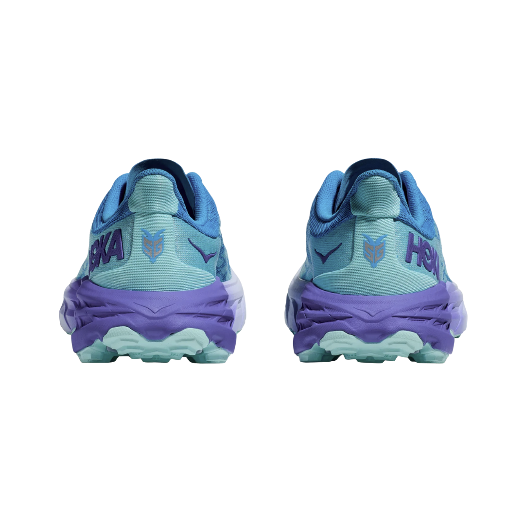 Back View of Women’s HOKA Speedgoat 5 Trail Running Shoe in Cloudless/Cosmos – featuring Vibram® Megagrip rubber outsole with aggressive 5mm lugs, zonal traction for varied surfaces, and extended heel for added control on descents.