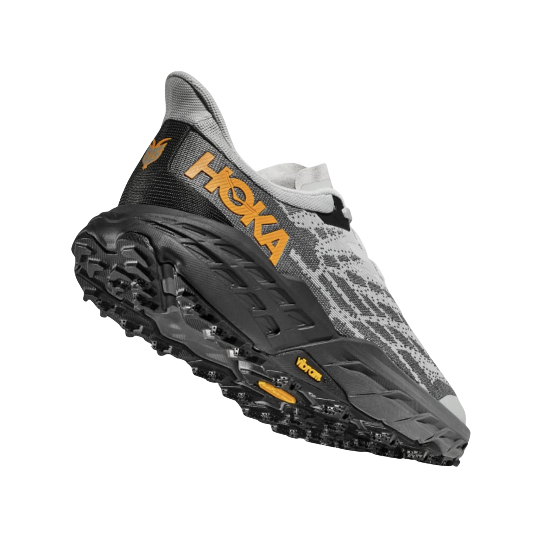 Angled View of Men’s HOKA Speedgoat 5 Trail Running Shoe in Harbor Mist/Black – featuring lightweight cushioned midsole, durable trail-ready upper, and aggressive lugged outsole for all-terrain performance.