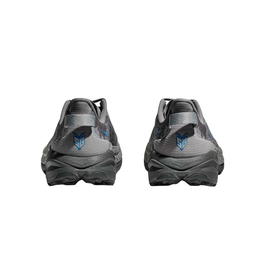 Back view of Men’s Hoka Speedgoat 6 trail running shoe in galactic grey and Hoka blue – featuring molded heel counter for rearfoot stability, pull tab for easy on and off, and reflective accents for visibility in low-light conditions.