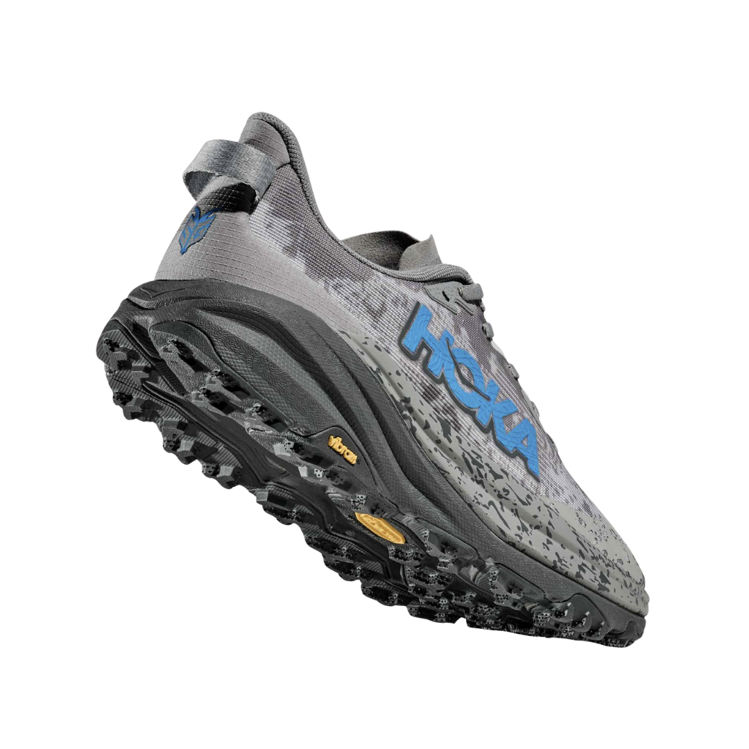 Angled View of Men’s HOKA Speedgoat 6 Trail Running Shoe in Galactic Grey/HOKA Blue – featuring updated streamlined upper, cushioned yet responsive ride, and enhanced traction for challenging surfaces.
