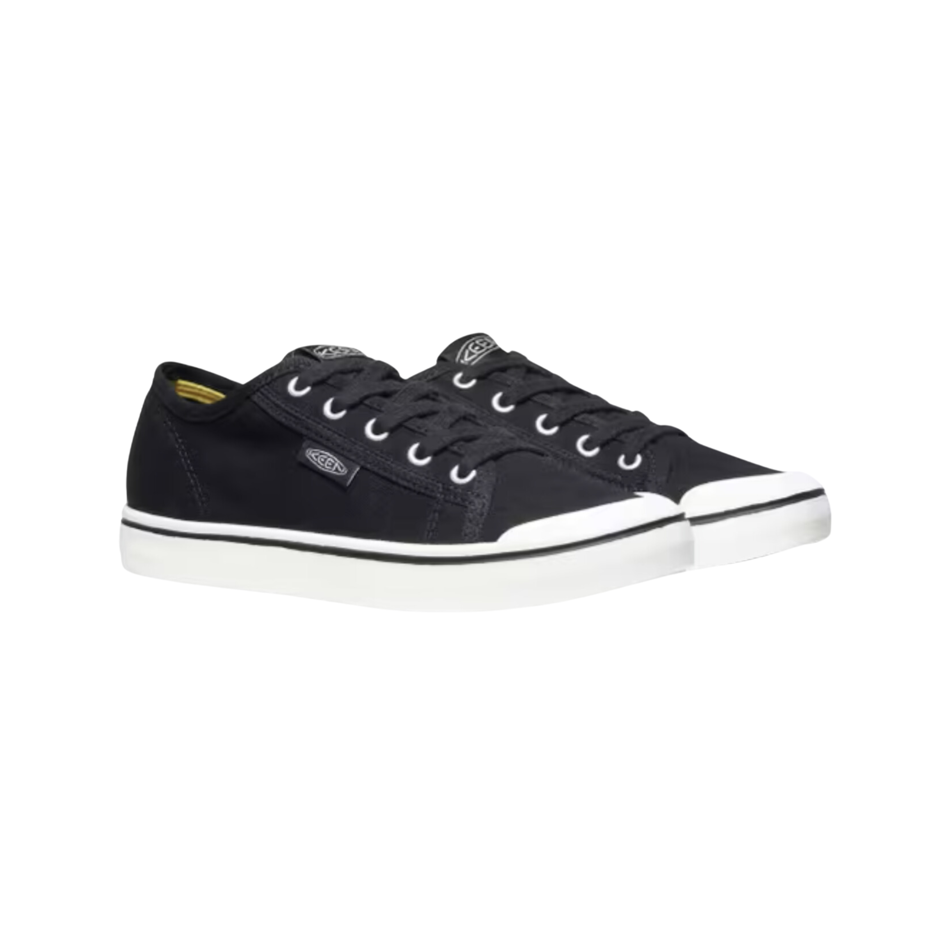 Side view of Women’s Elsa Lite sneaker in black and star white – featuring a lightweight canvas upper for breathable comfort, streamlined low-top design for everyday wear, and cushioned footbed for all-day support.