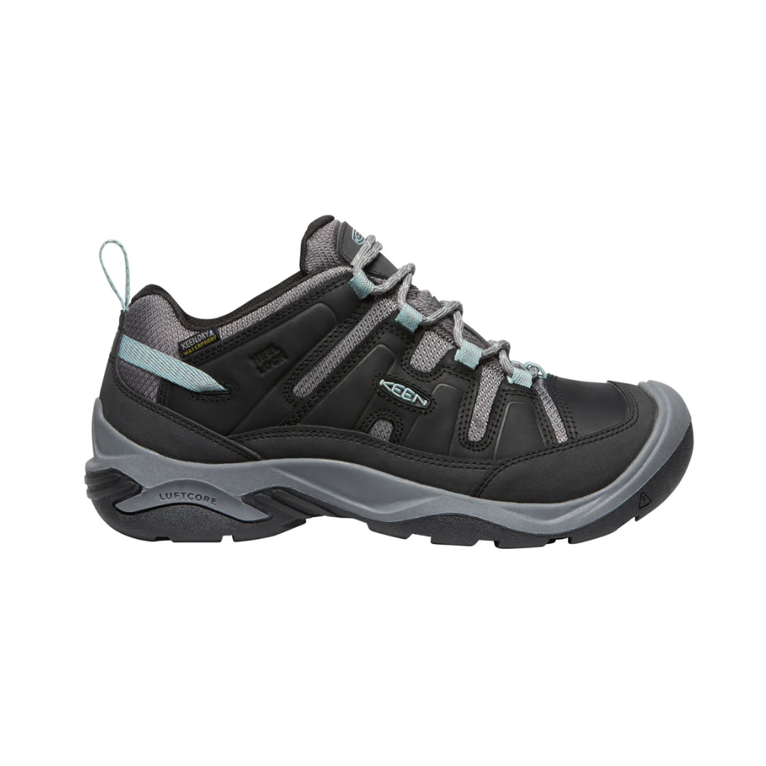 Side view of Women’s Circadia Low Waterproof hiking shoe in black and cloud blue – featuring a waterproof nubuck leather and mesh upper for weather protection, cushioned midsole with advanced shock absorption to reduce joint strain, and reinforced toe and heel overlays for durability.