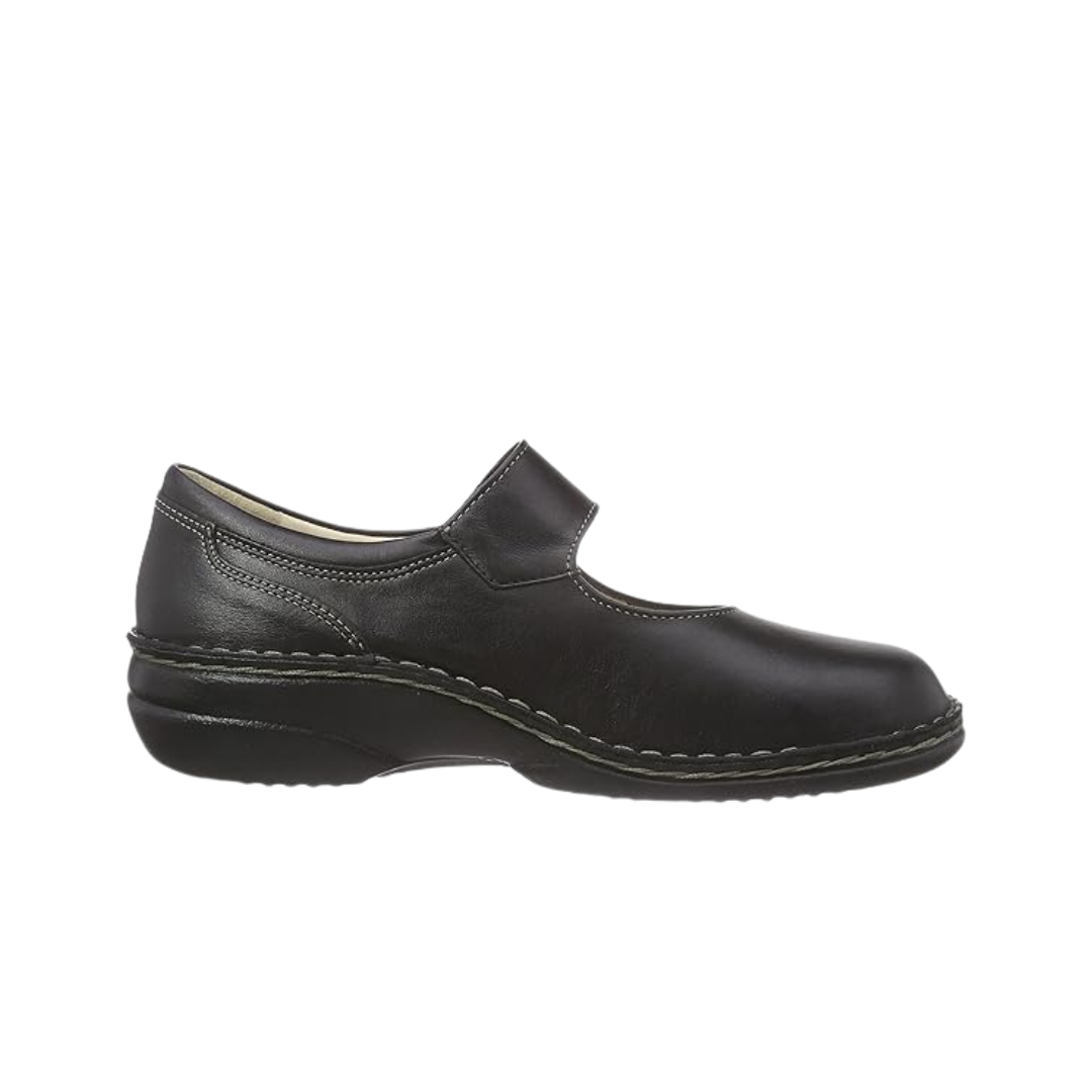 Side View of Women’s Finn Comfort Laval Mary Jane shoe in Black Nappa leather – featuring a single adjustable hook-and-loop strap with a decorative metal medallion, a removable contoured cork footbed for anatomical support, and a flexible polyurethane outsole for shock absorption and stability.