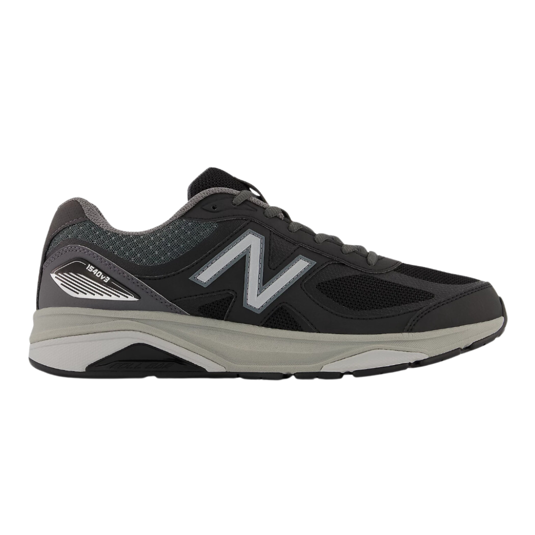 Side view of Men’s New Balance 1540v3 athletic shoe in black, grey, and white – featuring premium leather and mesh upper, cushioned midsole, and supportive outsole.