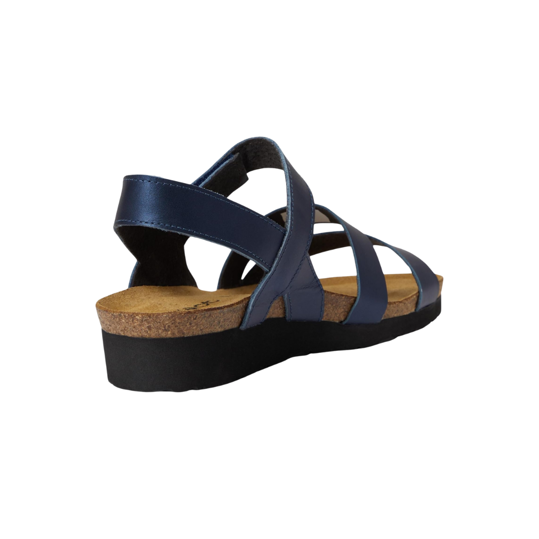 Angled view of Women’s Kayla in Polar Sea Leather – capturing the soft blue leather finish, sleek strap configuration, and contoured sole built for casual versatility and day-to-night comfort.