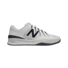 Side view of Men’s New Balance Court 1006 pickleball shoe in white, grey, and black – featuring breathable mesh and synthetic upper for support, cushioned midsole for comfort during lateral movements, durable outsole with traction pattern for court grip, and low-profile design for agility.