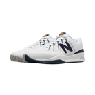 Side View of Men’s New Balance Court 1006 Shoe in White with Navy – featuring smooth leather and synthetic upper for durability, cushioned midsole for comfort, and rubber outsole for traction.