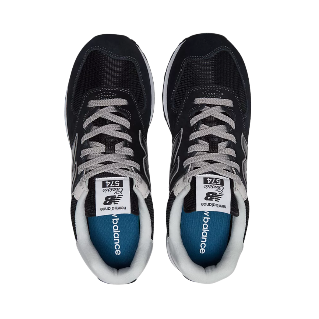 Top view of Men’s New Balance 574 casual sneaker in black/white/grey – featuring a padded collar, breathable mesh tongue, and classic lace-up closure for a secure fit.