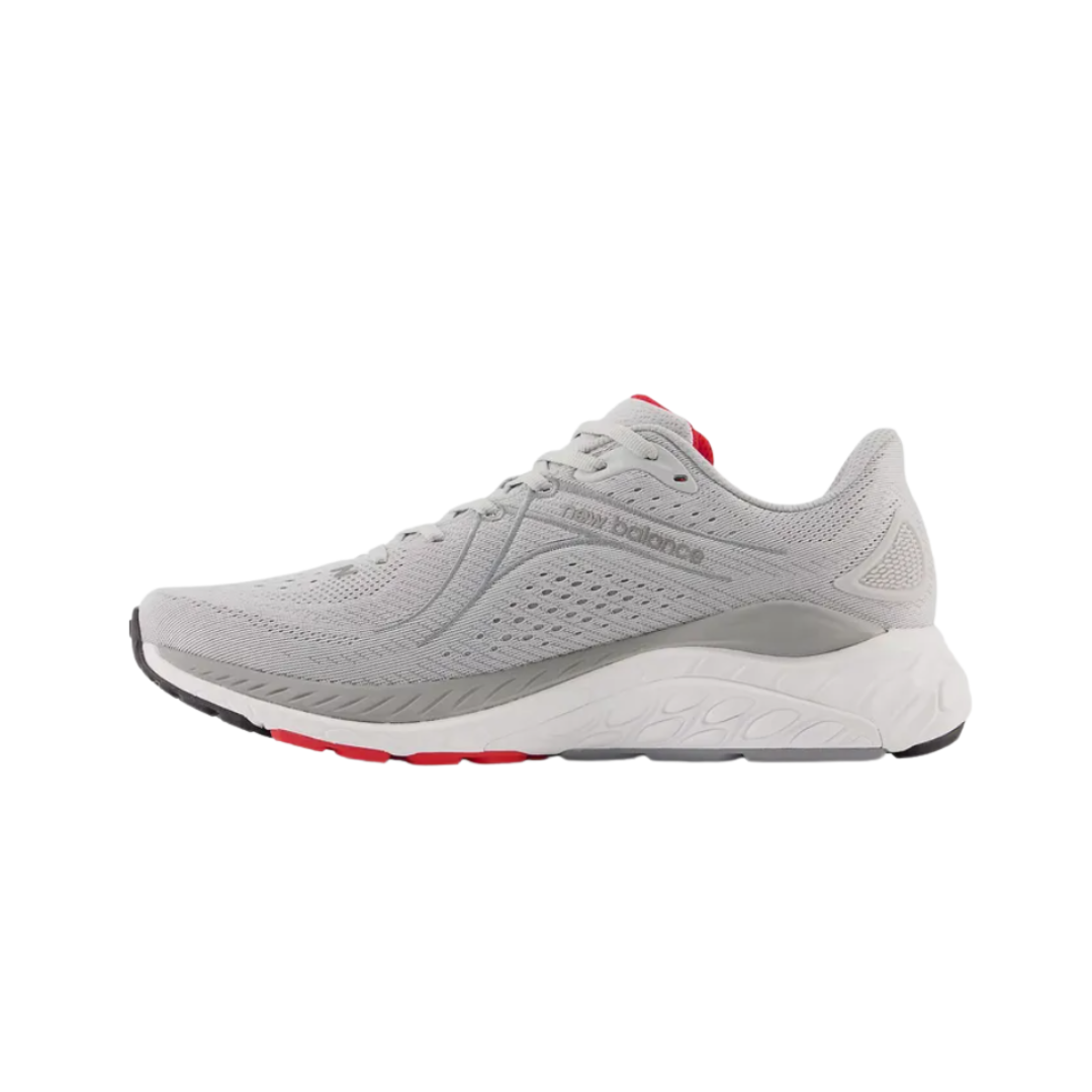 Side view of Men’s New Balance Fresh Foam X 860v13 running shoe in light aluminum, true red, and black – featuring reinforced toe box, breathable mesh tongue, and padded forefoot for comfort.