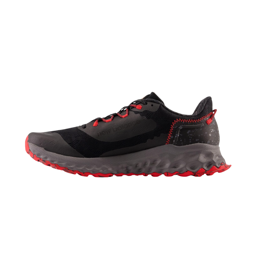 Side View of Men’s New Balance Fresh Foam X Garo v1 trail running shoe in magnet with true red and black – featuring engineered mesh upper for lightweight breathability, Fresh Foam X midsole for plush underfoot cushioning, and aggressive trail-specific outsole for enhanced traction.