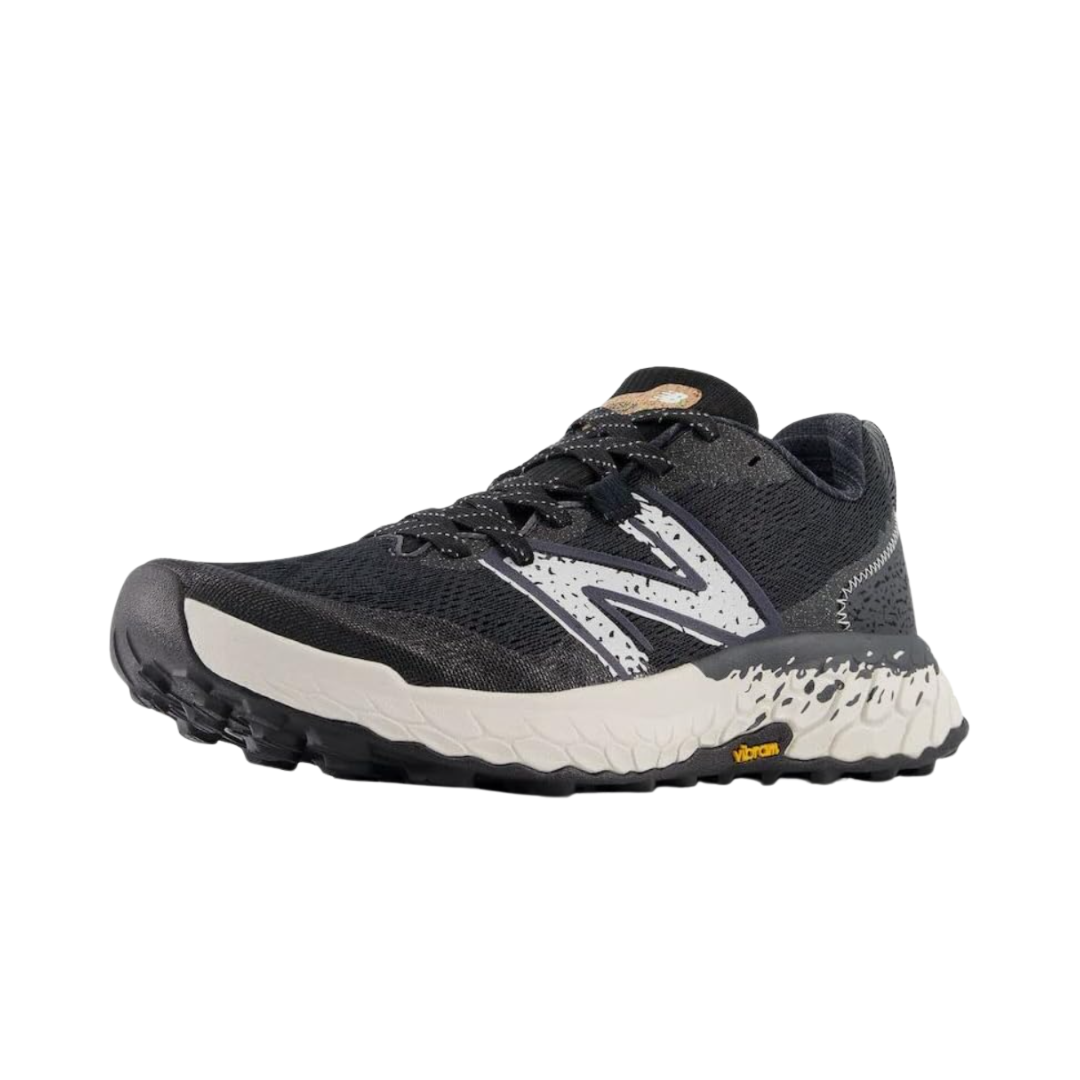 Side View of Men’s New Balance Fresh Foam X Hierro v7 trail running shoe in black reflection with white – featuring engineered mesh upper for breathability, Fresh Foam X midsole cushioning for plush comfort, and Vibram® outsole for rugged trail traction.