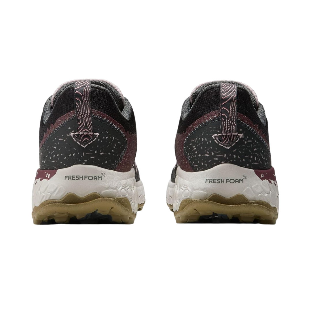 Bottom view of Women’s New Balance Fresh Foam X Hierro v7 in Stone Pink/Blacktop/Washed Burgundy – featuring Vibram® Megagrip rubber outsole with multi-directional lugs for enhanced traction on varied terrains.