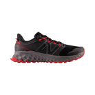 Side view of Men's New Balance Fresh Foam x Garoe v1 athletic shoe in magnet, true red, and black – featuring cushioned Fresh Foam midsole, breathable mesh upper, and durable rubber outsole for traction.