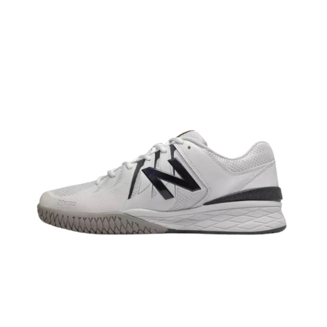 Side View of Men’s New Balance Court 1006 sneaker in white with navy – featuring reinforced toe cap for added protection during play, roomy toe box to allow natural toe splay, and secure lace-up closure for a customized fit.