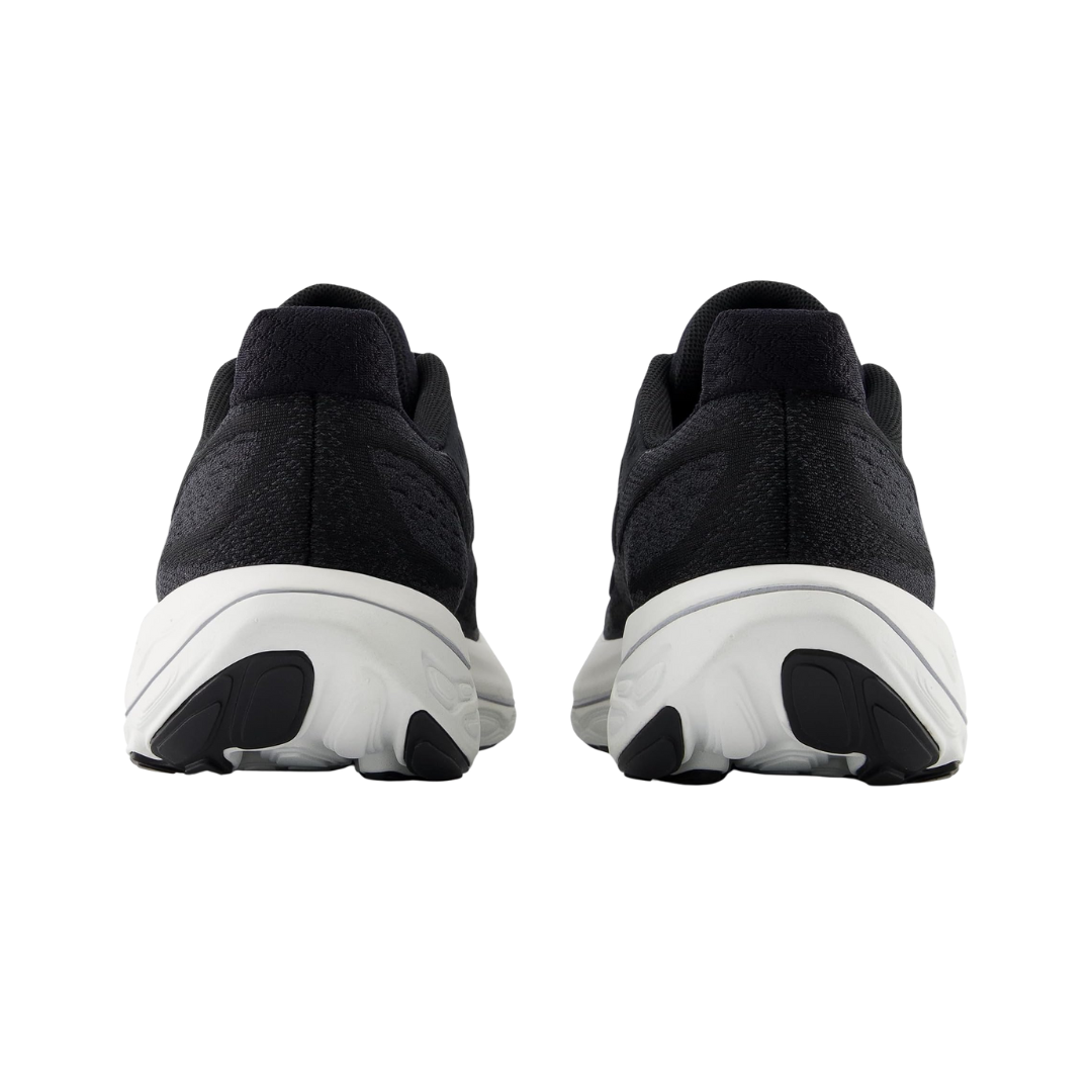 Back View of Women’s New Balance Fresh Foam X Vongo v6 running shoe in black with white – featuring structured heel counter, pull tab for easy on and off, and cushioned collar for ankle support.