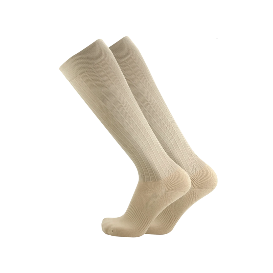 Side view of unisex OS1st Travel knee socks in tan – featuring compression to improve circulation and reduce swelling, breathable fabric, cushioned sole for comfort, and knee-high coverage ideal for long periods of sitting or standing.
