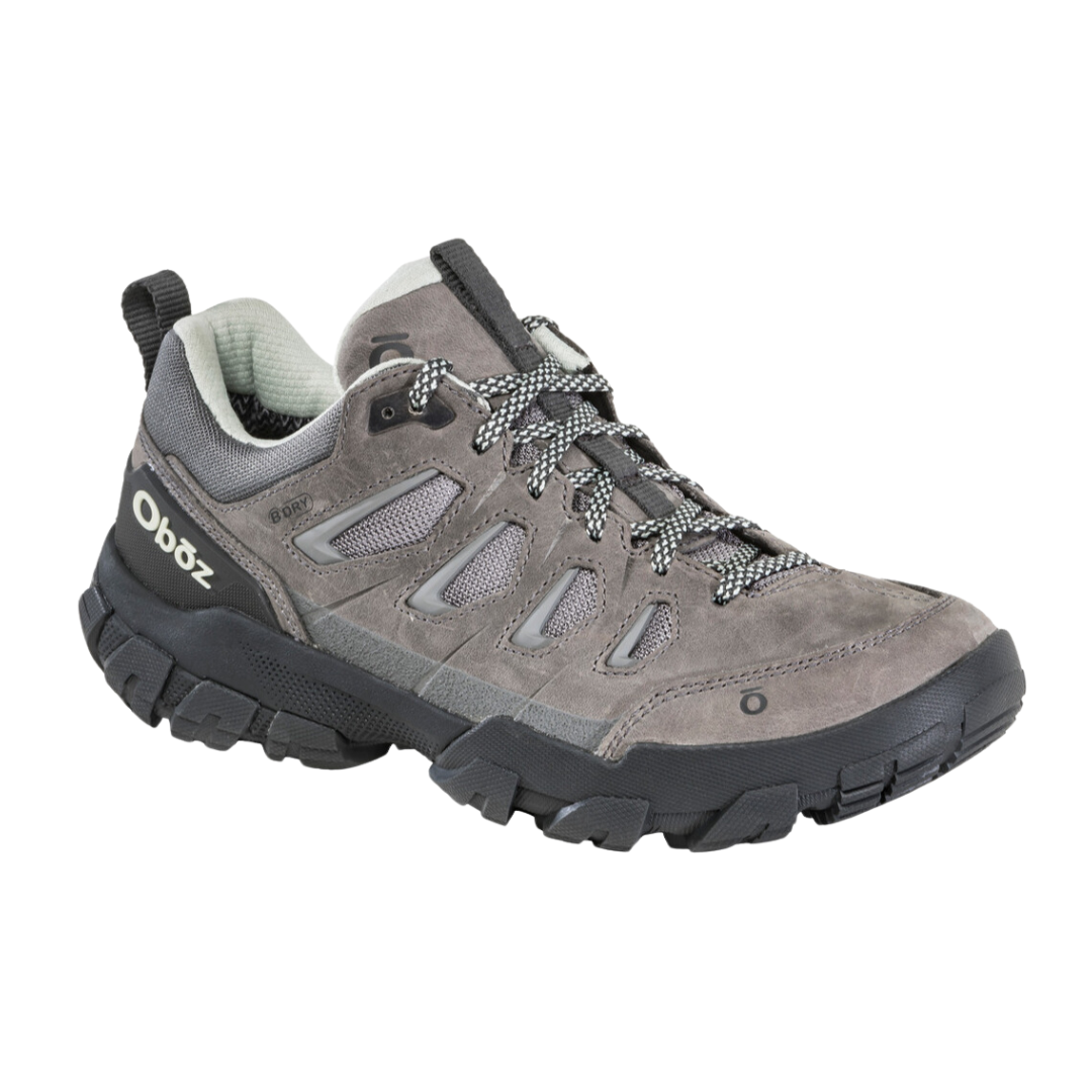 Angled view of Women's Sawtooth X B-Dry hiking shoe in Hazy Grey – featuring a waterproof nubuck and textile upper, cushioned midsole for supportive comfort, and an aggressive outsole design ideal for versatile hiking adventures.